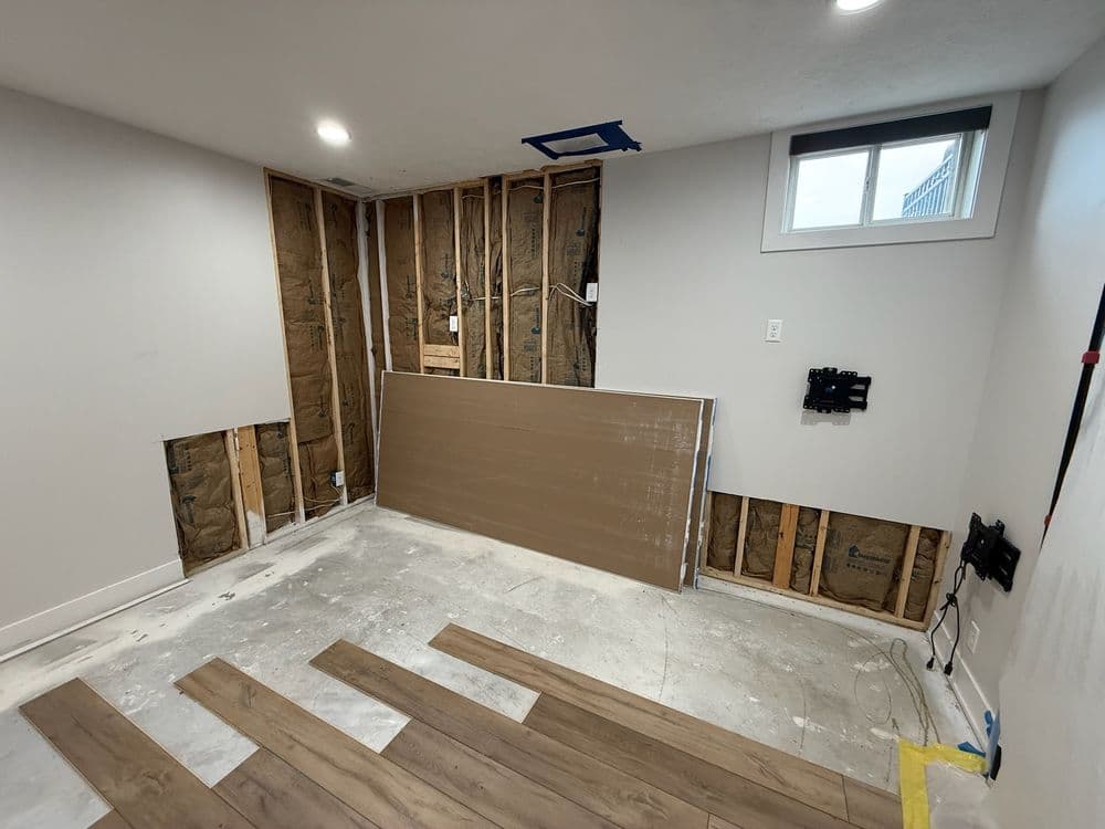 Renovation in progress: empty room with exposed walls, flooring, and unfinished space.